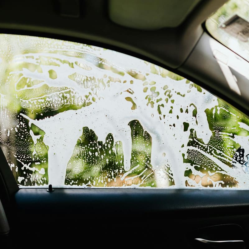 Water beading sheeting down a freshly rinsed car