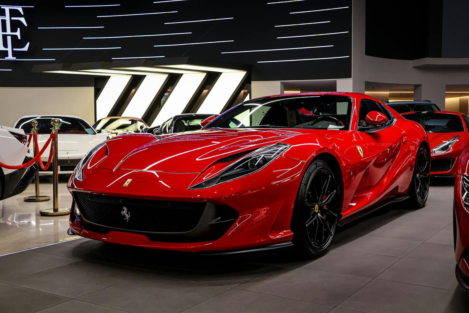 Red luxury sports car in showroom lighting